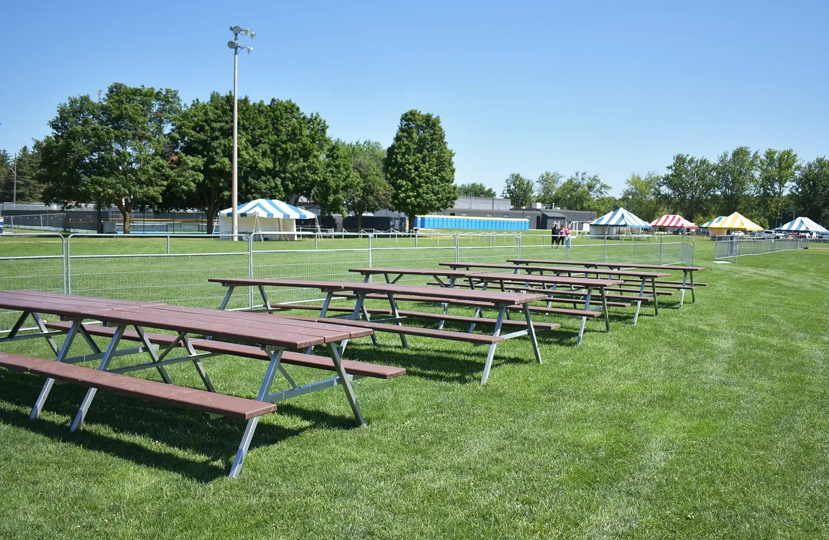 Temporary crowd control barriers creating safe walkways and restricted-access areas for public events