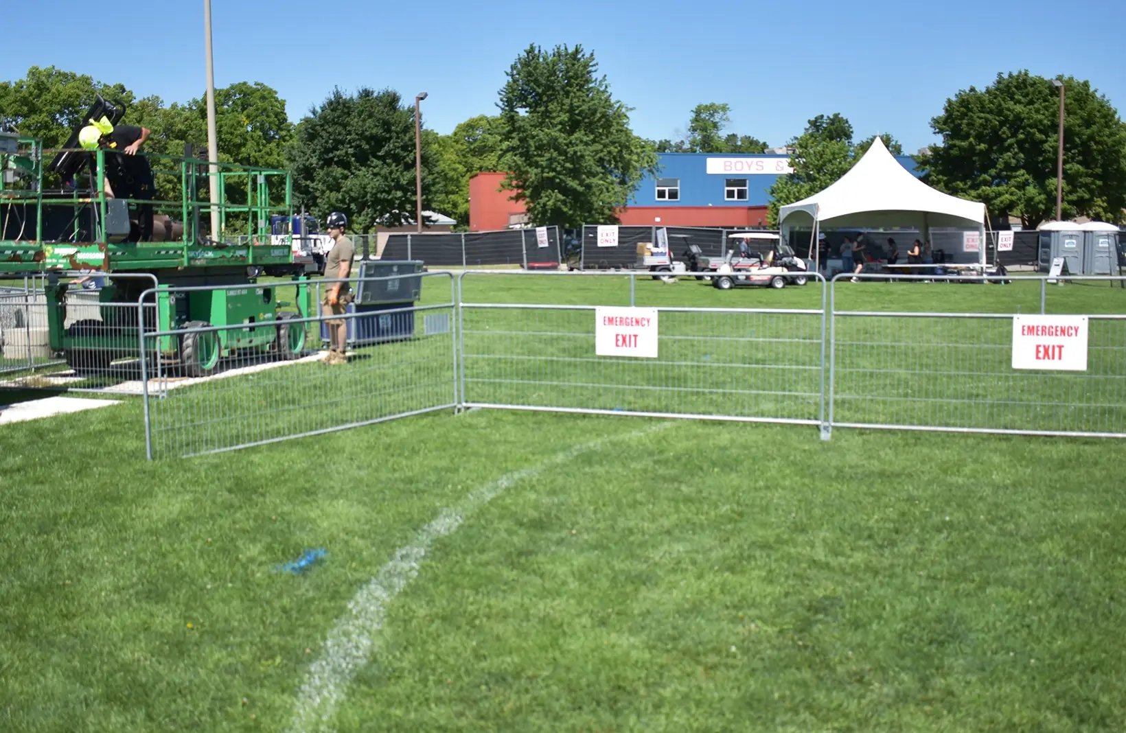 Temporary crowd control barriers creating safe walkways and restricted-access areas for public events