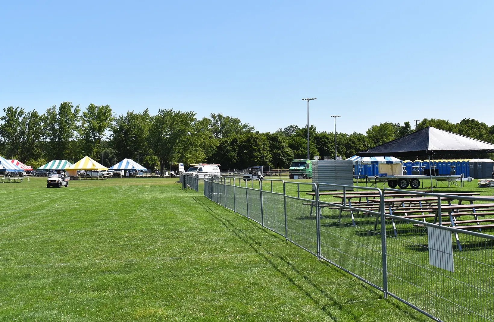 Temporary crowd control barriers creating safe walkways and restricted-access areas for public events