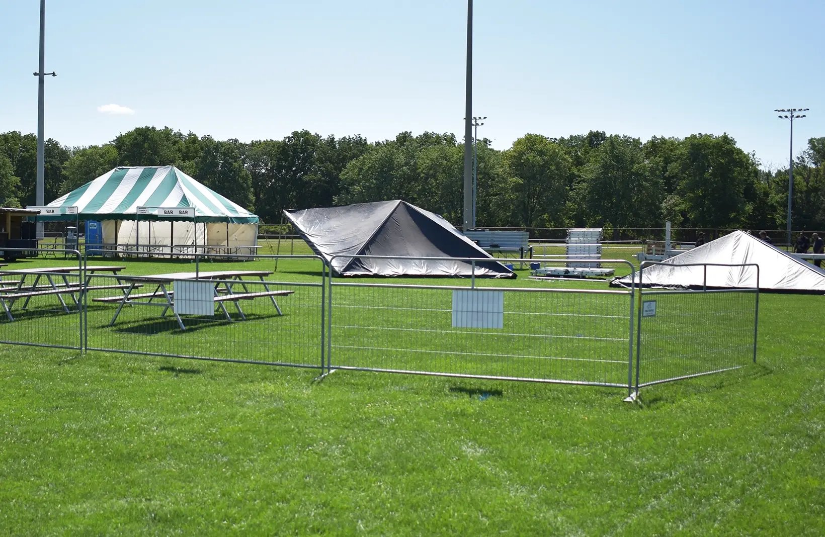 Temporary crowd control barriers creating safe walkways and restricted-access areas for public events